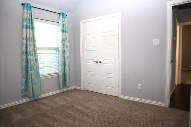 a large kitchen with stainless steel appliances granite countertop a refrigerator a sink dishwasher a stove and white countertops with wooden floor