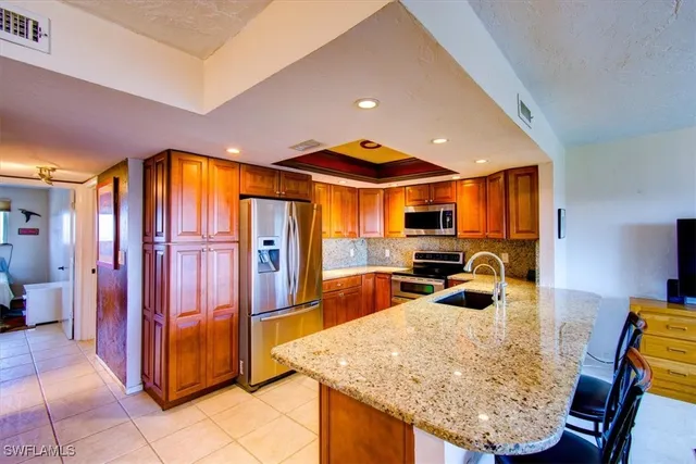 a kitchen with stainless steel appliances granite countertop a sink and cabinets