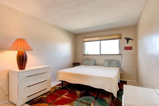 a bedroom with a bed and a desk