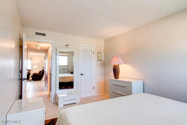 a bedroom with a bed and a view of bathroom