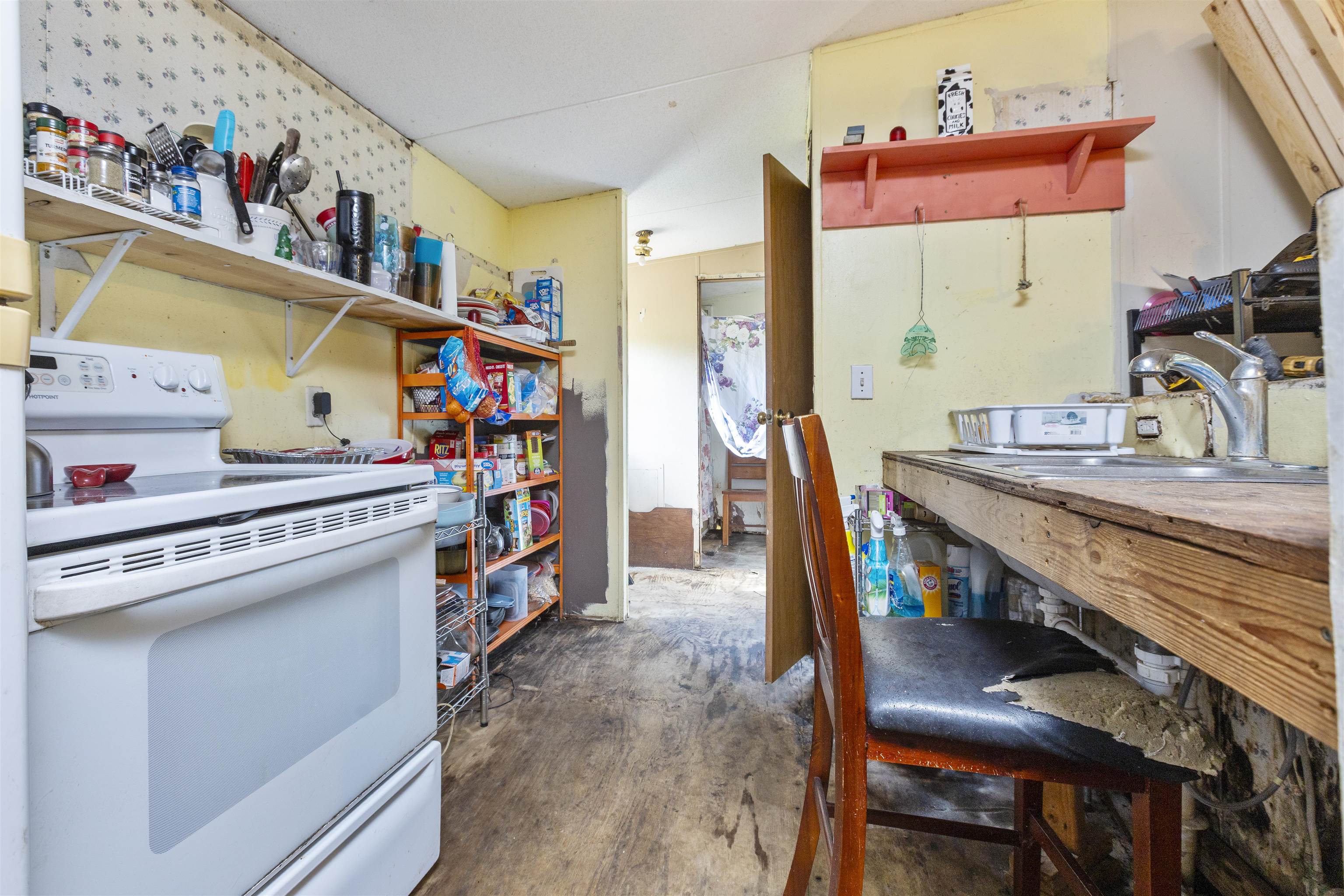 1931 Ryan Road St. Augustine, FL 32092 - Photo 25 of 34 Kitchen featuring white electric stove, open shelves, and unfinished concrete floors