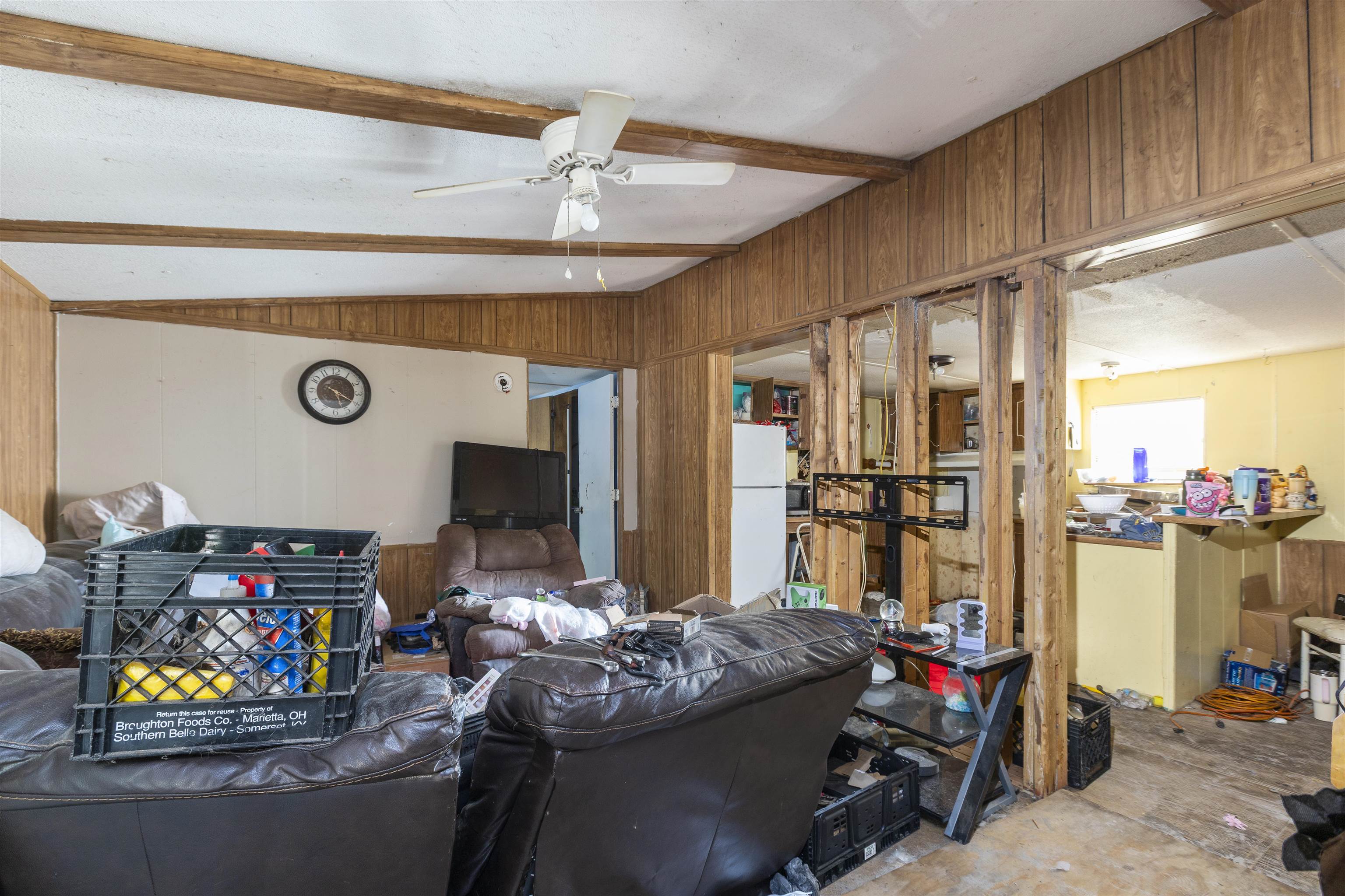 1931 Ryan Road St. Augustine, FL 32092 - Photo 33 of 34 Living room featuring vaulted ceiling with beams, wooden walls, and a ceiling fan