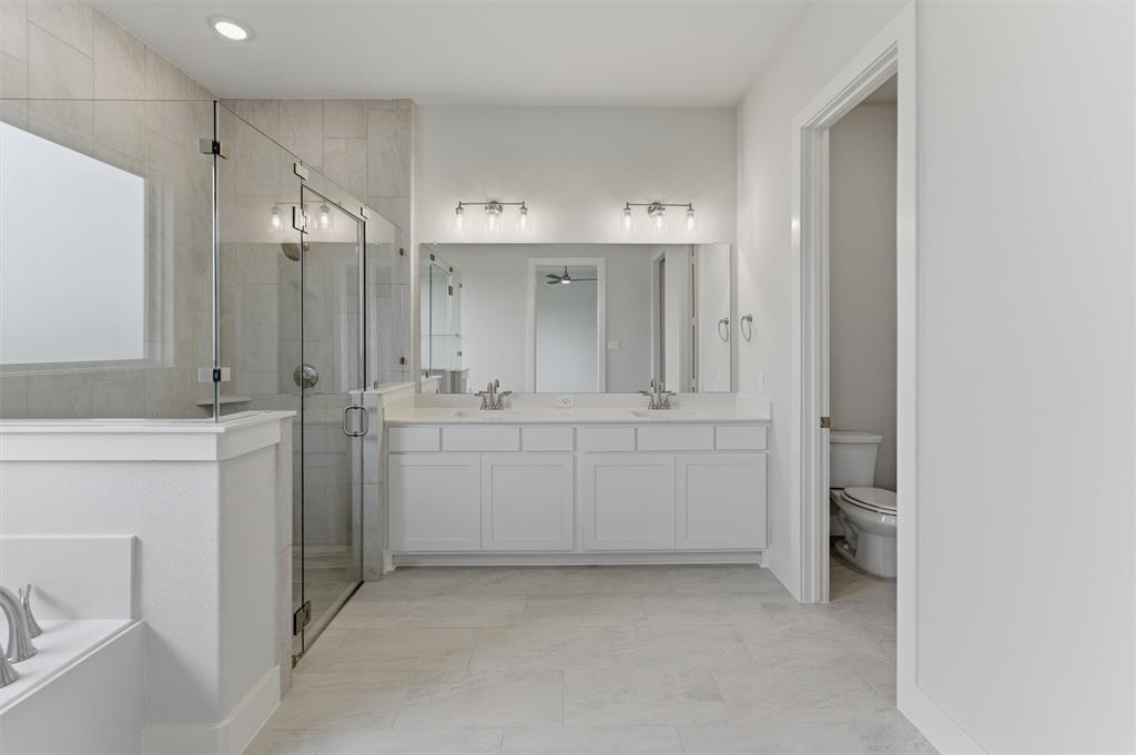 2316 Quartz Street Krum, TX 76249 - Photo 20 of 29 Double vanity with white cabinetry, quartz-finish countertop, and undermount sinks