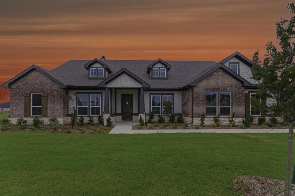 2316 Quartz Street Krum, TX 76249 - Photo 29 of 29 Exterior features include a dark asphalt shingle roof, dark brick and light siding, multiple gables, and decorative dormer windows