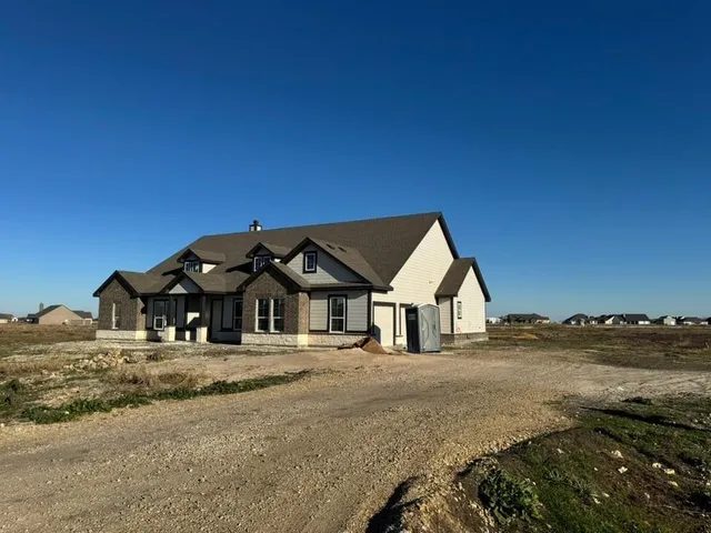 a view of a house with snow on the background