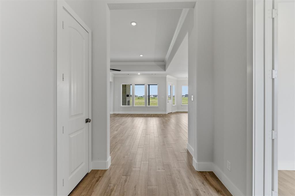 2316 Quartz Street Krum, TX 76249 - Photo 4 of 29 Hallway featuring wood-finish flooring, white trim, recessed lighting, and a white interior door