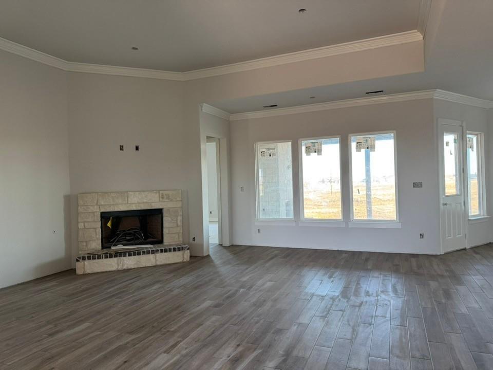 2316 Quartz Street Krum, TX 76249 - Photo 5 of 12 a view of an empty room with wooden floor fireplace and a window