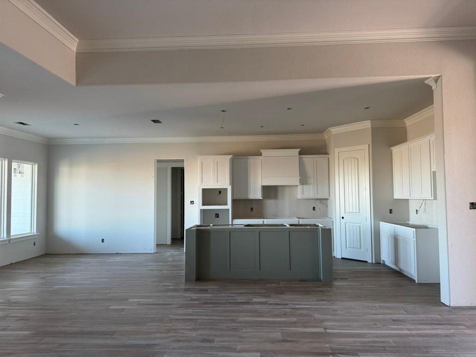 2316 Quartz Street Krum, TX 76249 - Photo 6 of 12 a view of a kitchen with kitchen island wooden floor center island and stainless steel appliances