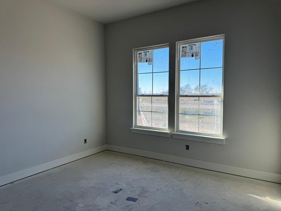 2316 Quartz Street Krum, TX 76249 - Photo 8 of 12 an empty room with windows