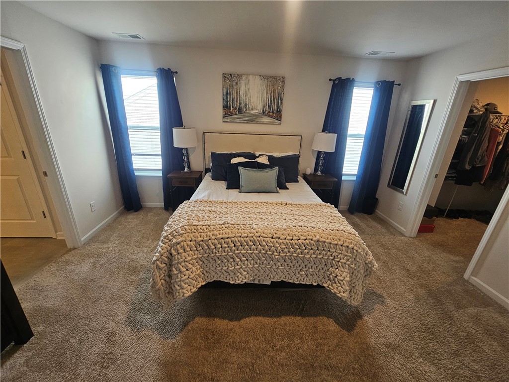 902 Ashwood Lane Easley, SC 29640 - Photo 19 of 39 Plush carpeting and well-lit windows provide a comforting ambiance to this sleeping area.