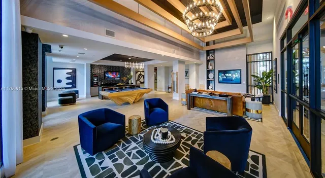 a living room with furniture and a chandelier