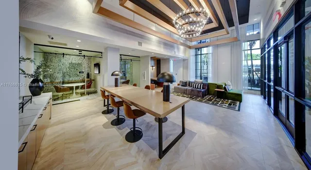 a living room with furniture a flat screen tv and a large window