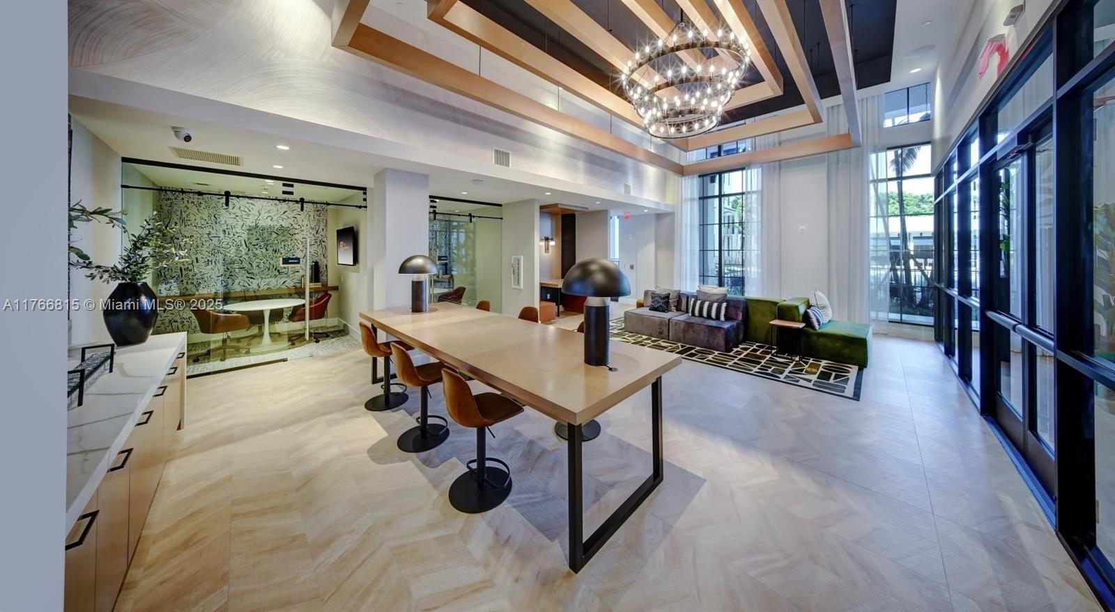 1301 Southwest 80th Terrace, Unit 205 Plantation, FL 33324 - Photo 13 of 16 a living room with furniture a flat screen tv and a large window