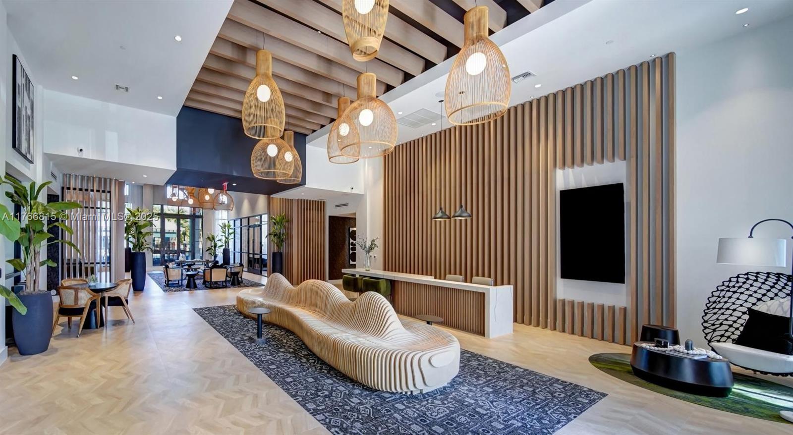 1301 Southwest 80th Terrace, Unit 205 Plantation, FL 33324 - Photo 15 of 16 a living room with furniture a fireplace and a chandelier