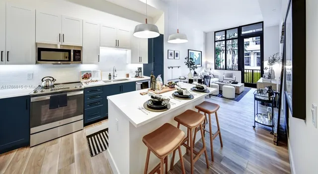 a kitchen with a sink a stove and chairs