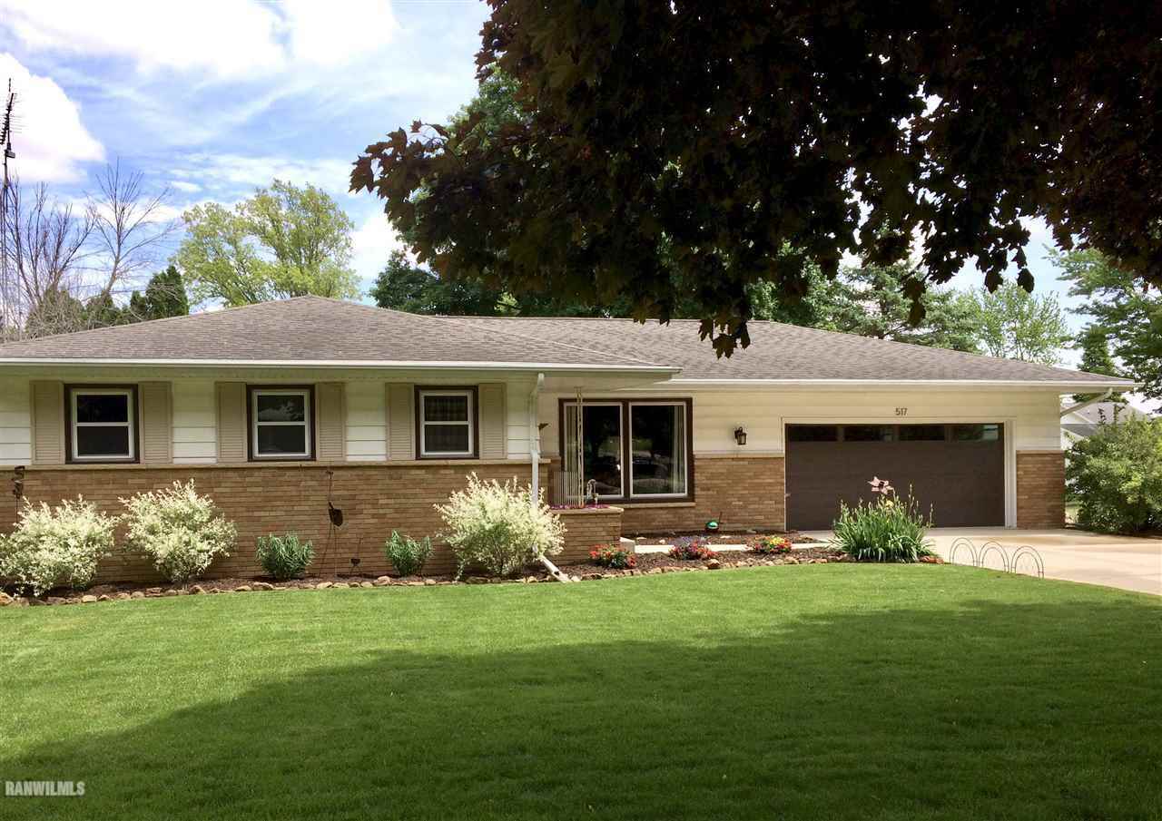 a front view of house with yard and outdoor seating
