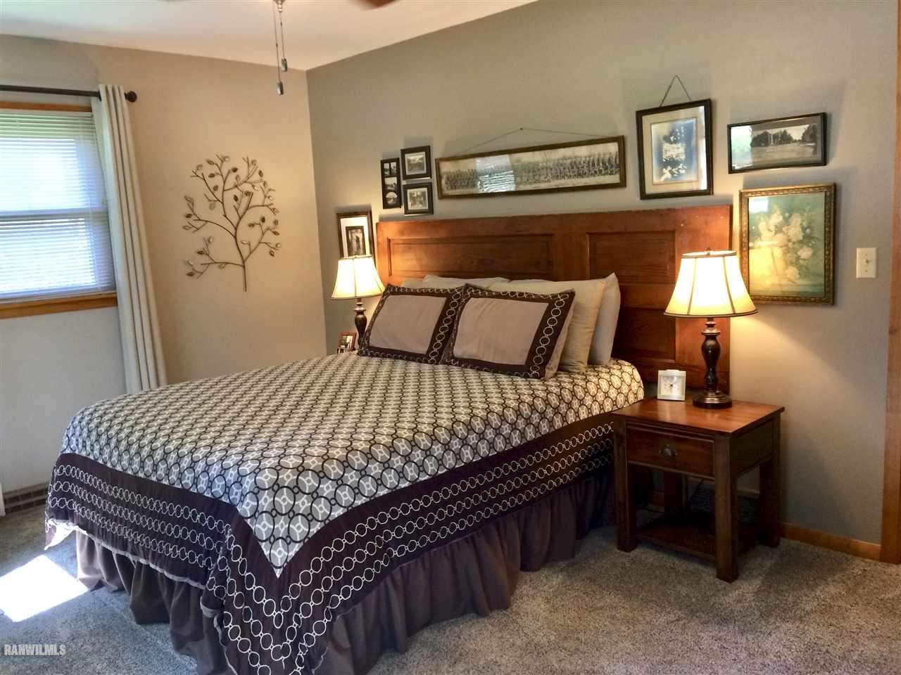 517 South Ridge Street Shannon, IL 61078 - Photo 12 of 21 a bedroom with a bed and painting on the wall