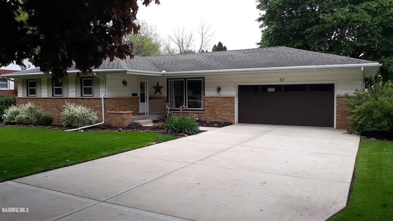 517 South Ridge Street Shannon, IL 61078 - Photo 2 of 21 a front view of a house with a garden and yard