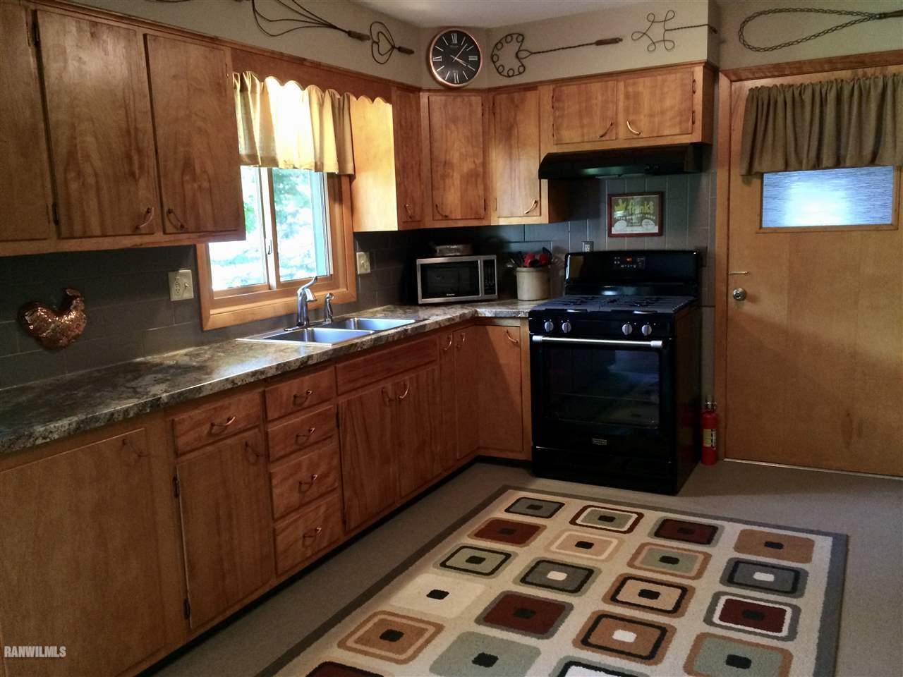 517 South Ridge Street Shannon, IL 61078 - Photo 6 of 21 a kitchen with stainless steel appliances a stove a sink and a microwave