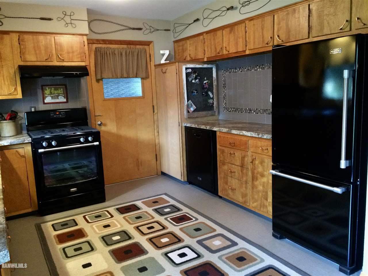 517 South Ridge Street Shannon, IL 61078 - Photo 7 of 21 a kitchen with granite countertop a stove and a refrigerator