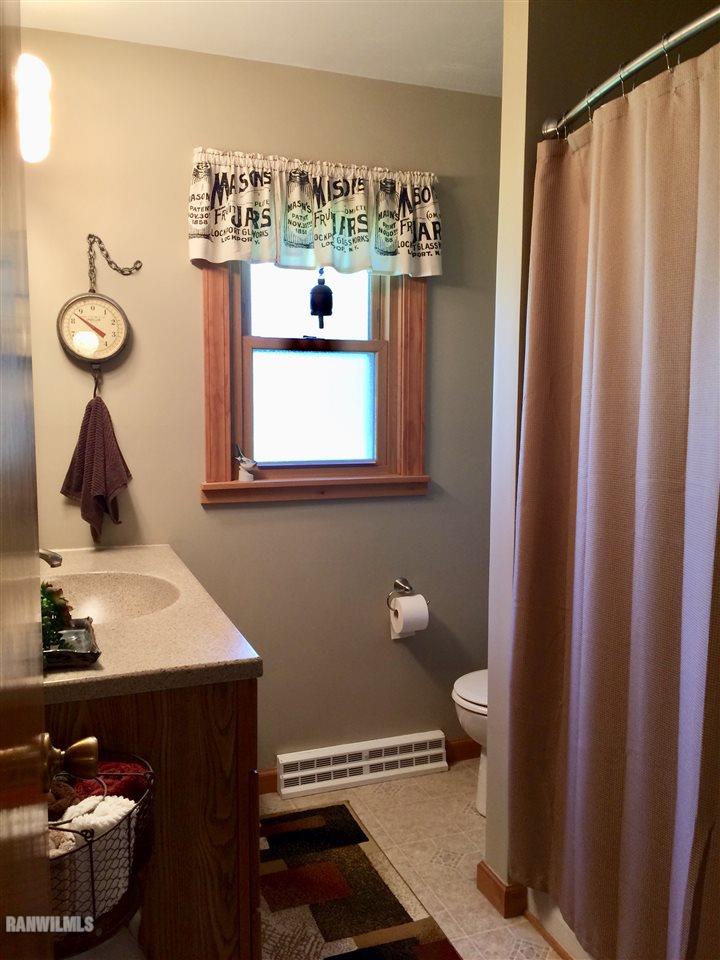 517 South Ridge Street Shannon, IL 61078 - Photo 9 of 21 a bathroom with a sink toilet and a mirror