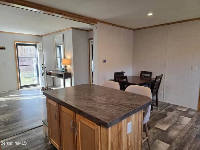 a dining table with chairs and wooden floor