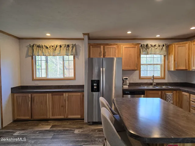 a kitchen with sink refrigerator and window