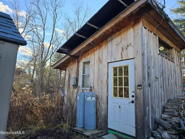 a view of a house with a door and wooden walls
