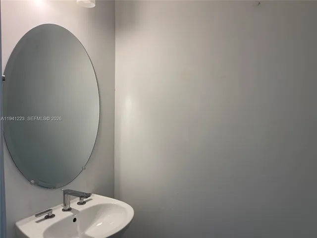 a bathroom with a sink and mirror