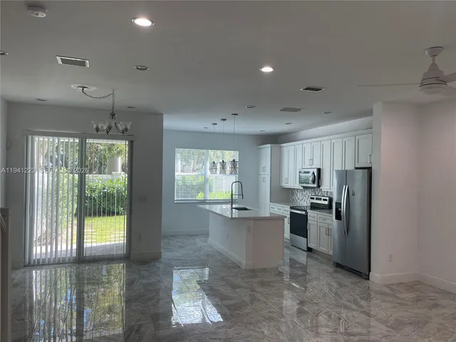 a kitchen with refrigerator and window