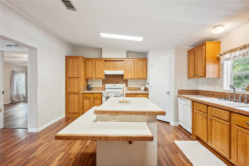 3319 Fox Ridge Boulevard Wesley Chapel, FL 33543 - Photo 14 of 50 a large kitchen with kitchen island a sink stainless steel appliances and cabinets