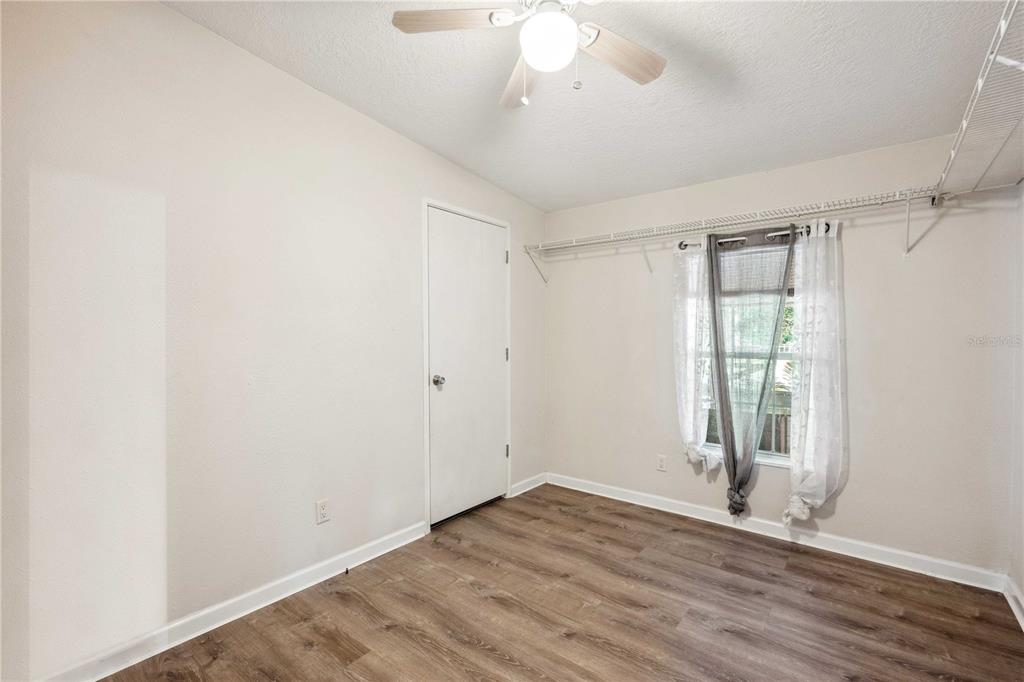 3319 Fox Ridge Boulevard Wesley Chapel, FL 33543 - Photo 31 of 50 an empty room with wooden floor and windows