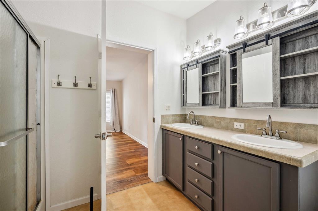 3319 Fox Ridge Boulevard Wesley Chapel, FL 33543 - Photo 32 of 50 a spacious bathroom with a double vanity sink a mirror and a shower