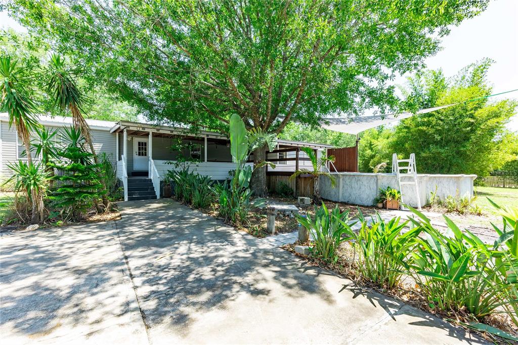 3319 Fox Ridge Boulevard Wesley Chapel, FL 33543 - Photo 43 of 50 a backyard of a house with barbeque oven and outdoor seating