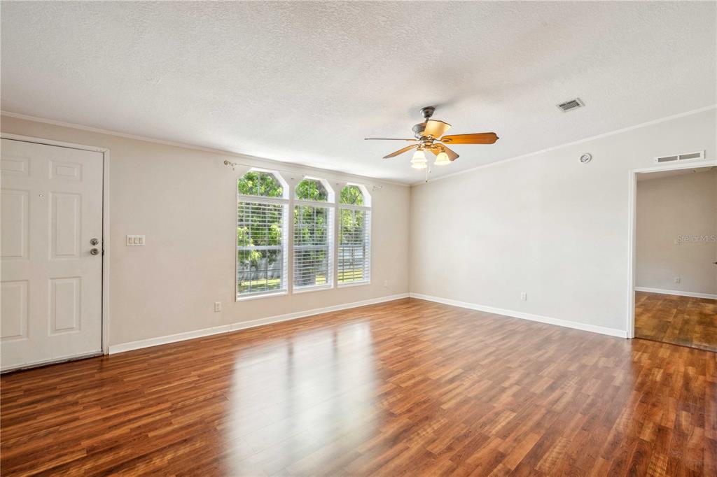 3319 Fox Ridge Boulevard Wesley Chapel, FL 33543 - Photo 5 of 50 wooden floor in an empty room with a window