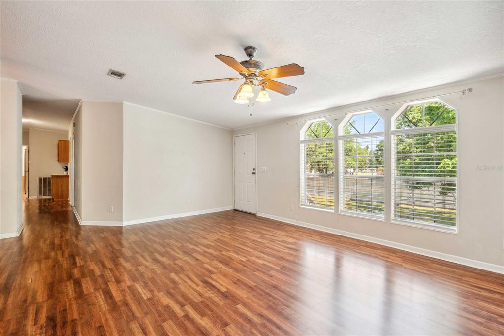 3319 Fox Ridge Boulevard Wesley Chapel, FL 33543 - Photo 6 of 50 a view of n empty room with window and wooden floor