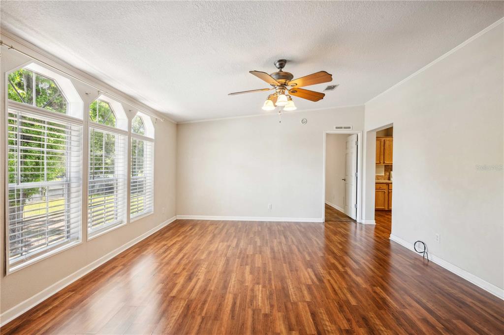 3319 Fox Ridge Boulevard Wesley Chapel, FL 33543 - Photo 7 of 50 a view of an empty room with a window and wooden floor