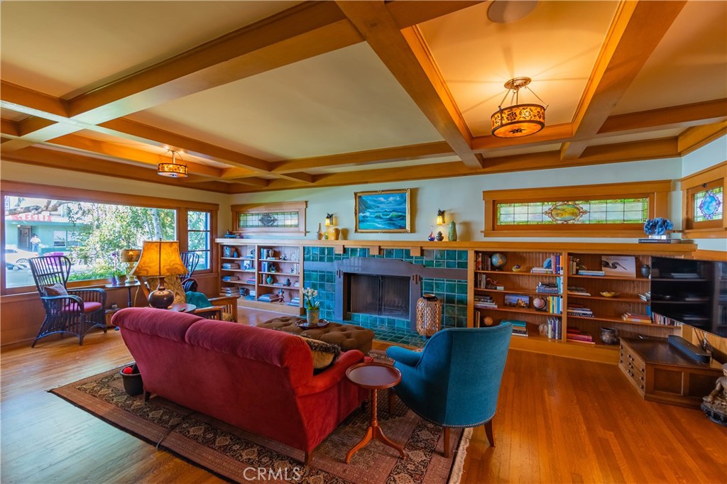 3216 2nd Street Long Beach, CA 90803 - Photo 11 of 62 a living room with furniture a fireplace and a floor to ceiling window