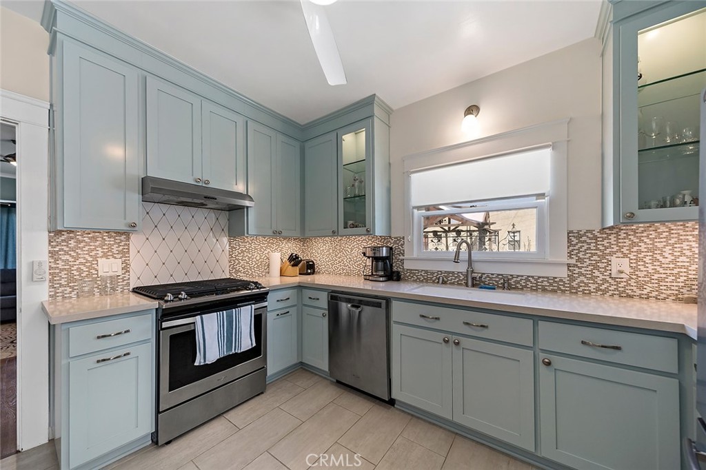 3216 2nd Street Long Beach, CA 90803 - Photo 47 of 62 a kitchen with stainless steel appliances granite countertop white cabinets and a sink