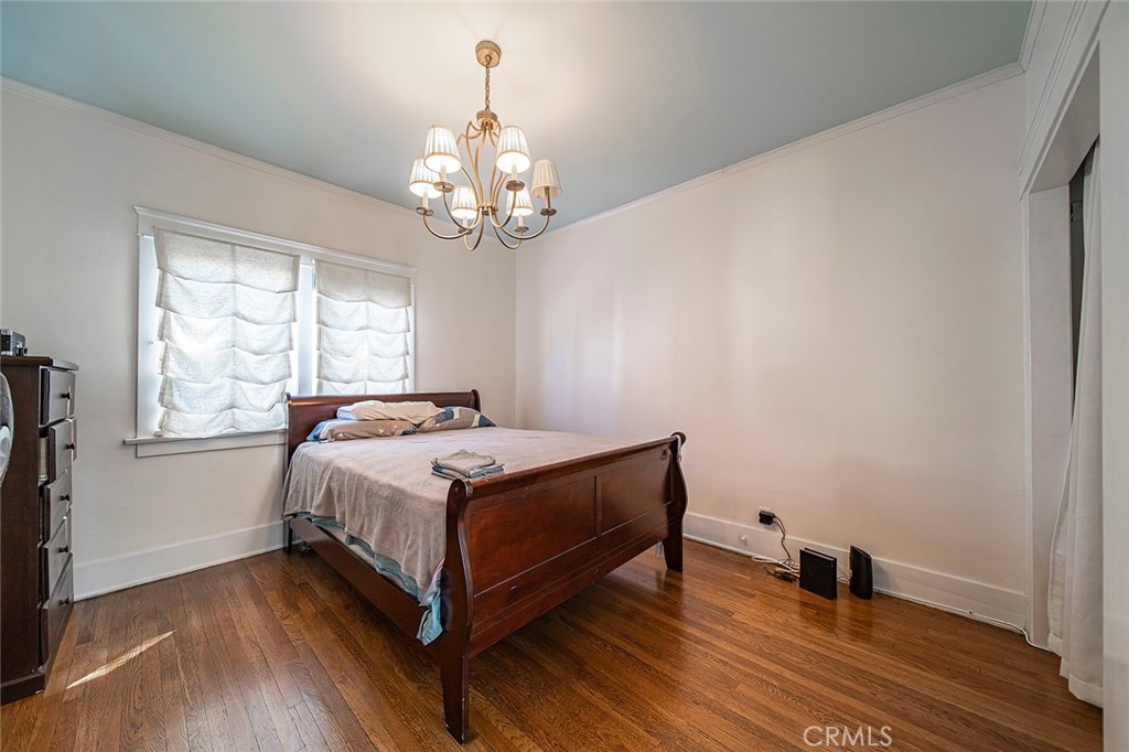 3216 2nd Street Long Beach, CA 90803 - Photo 50 of 62 a spacious bedroom with a bed and a chandelier
