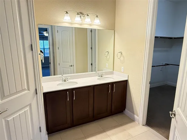 a bathroom with a shower sink and mirror
