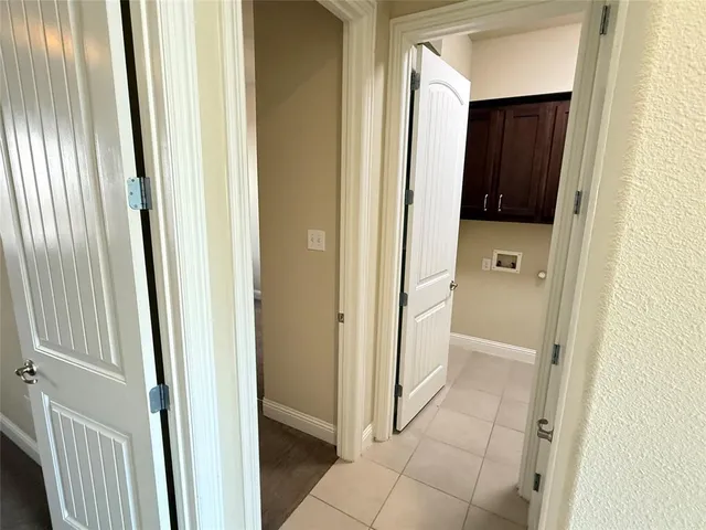 an empty room with chandelier fan