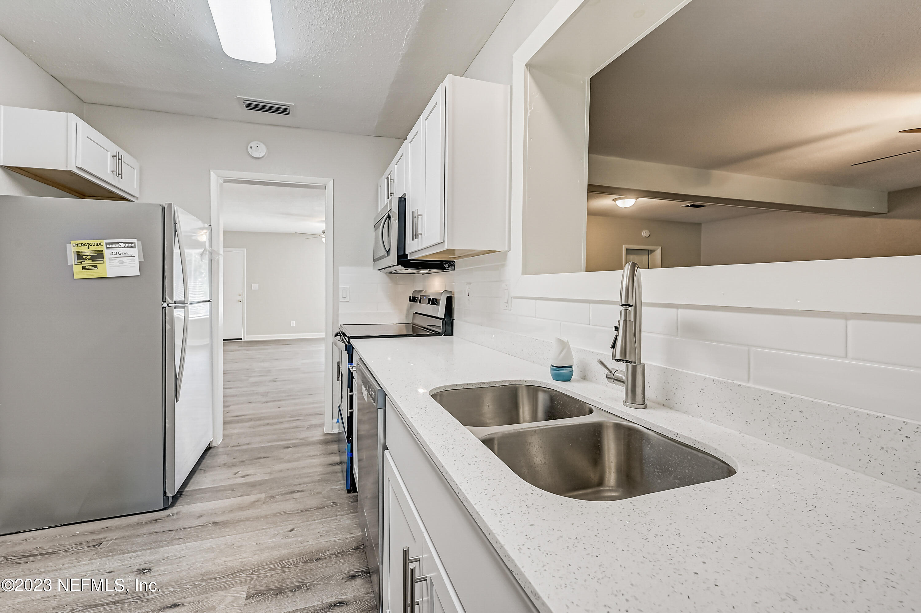 6105 Duke Road Jacksonville, FL 32217 - Photo 11 of 29 a kitchen with a sink and a refrigerator