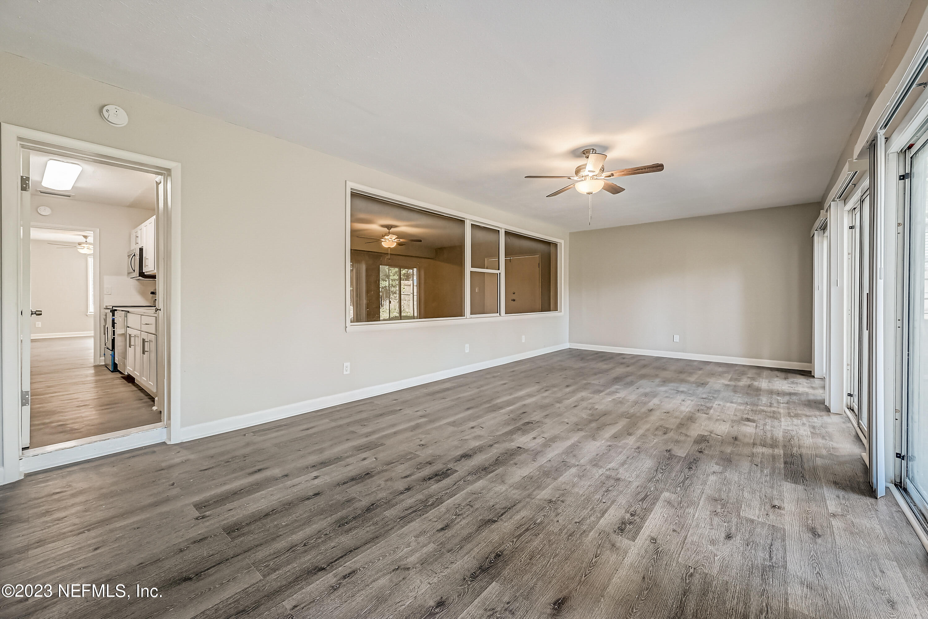 6105 Duke Road Jacksonville, FL 32217 - Photo 13 of 29 a view of empty room with wooden floor and fan