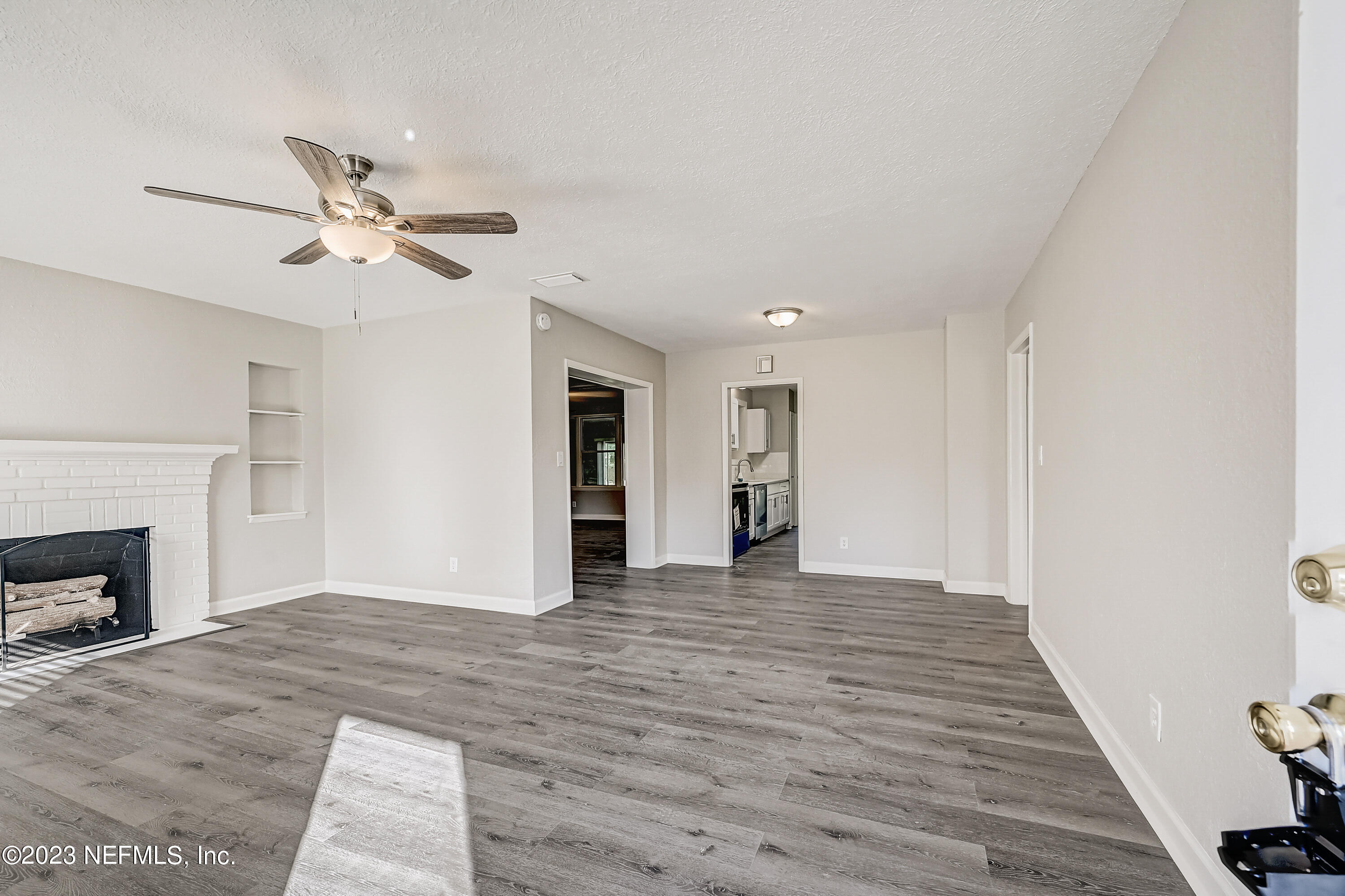 6105 Duke Road Jacksonville, FL 32217 - Photo 3 of 29 a view of empty room with wooden floor and fireplace