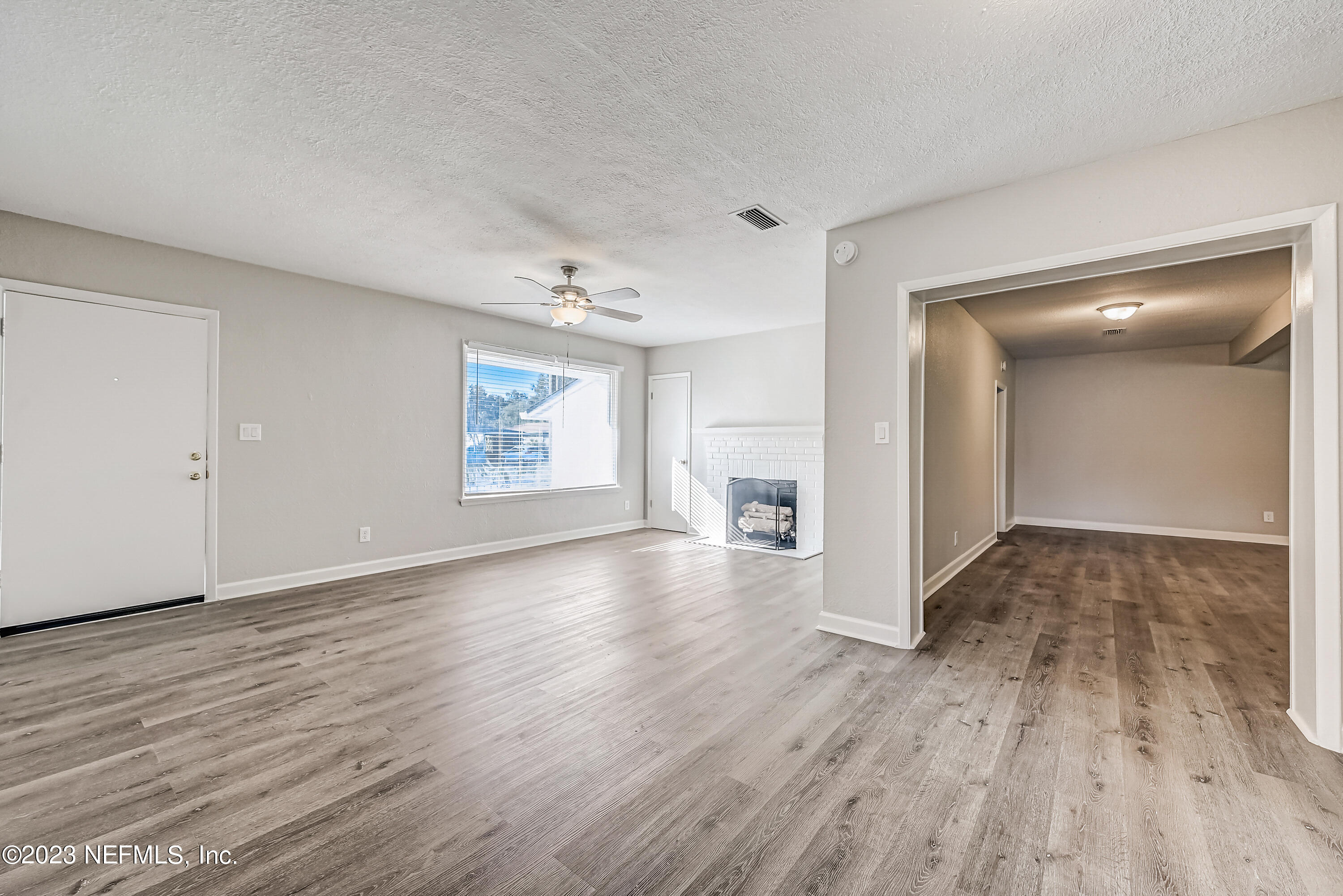 6105 Duke Road Jacksonville, FL 32217 - Photo 7 of 29 an empty room with wooden floor and windows