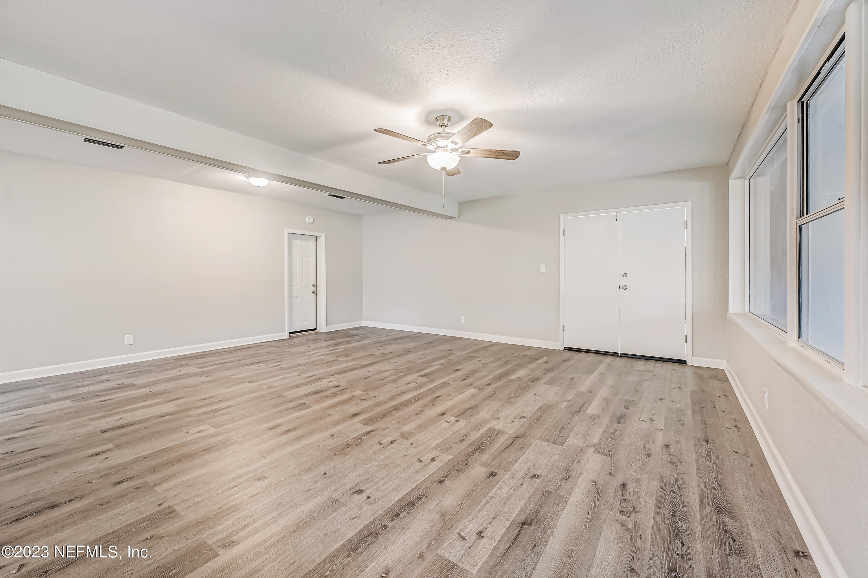 6105 Duke Road Jacksonville, FL 32217 - Photo 9 of 29 wooden floor in an empty room with a window