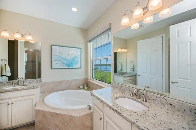a living room with furniture a fireplace and a large window