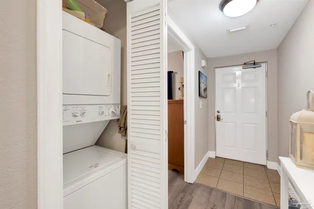 a bedroom with a bed and a flat tv screen on dresser