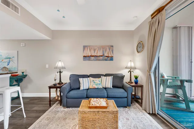 a kitchen with stainless steel appliances a dining table chairs and wooden floor
